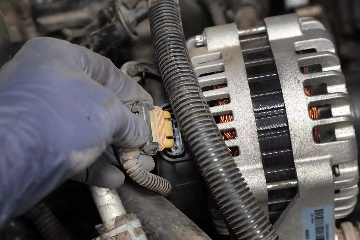 Plugging the control wires into the new alternator.