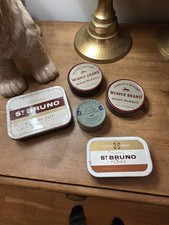 A collection of five vintage tins, including Ogden's St Bruno and Weaver Brand