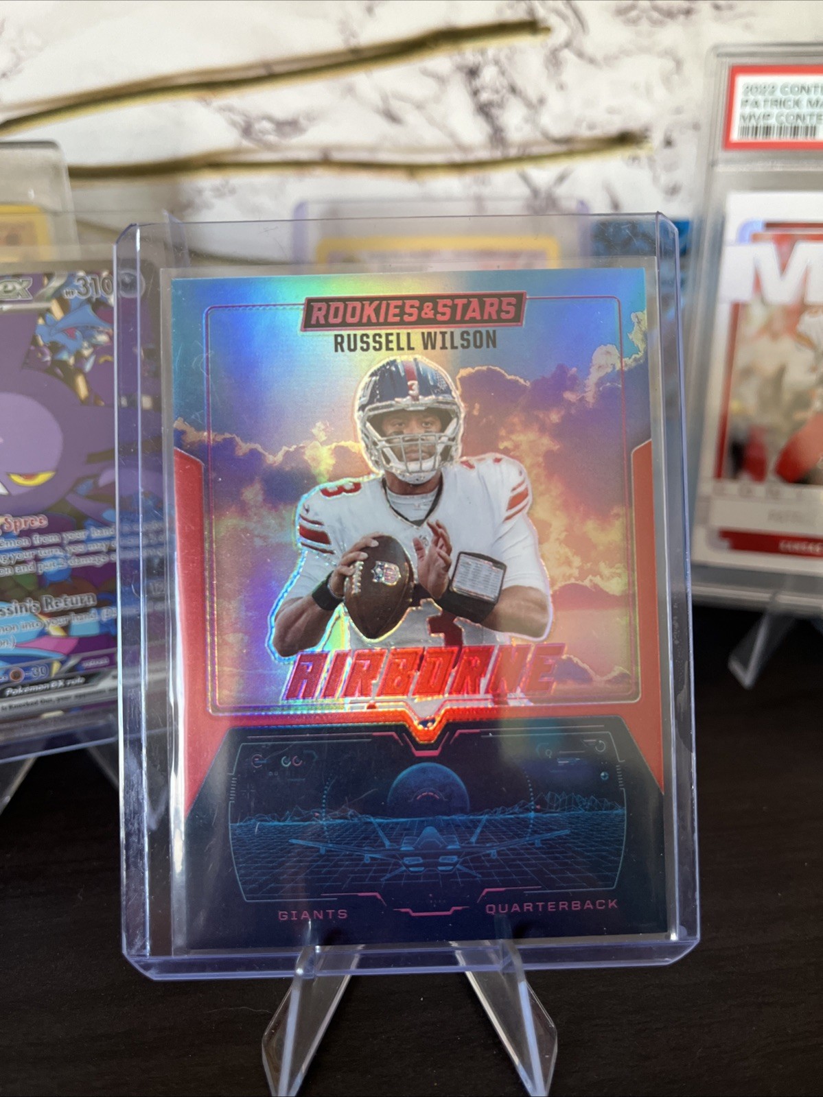 Russell Wilson #4 Football Cards 2025 Panini Rookies & Stars Airborne Signature trading card — raw and PSA graded price guide
