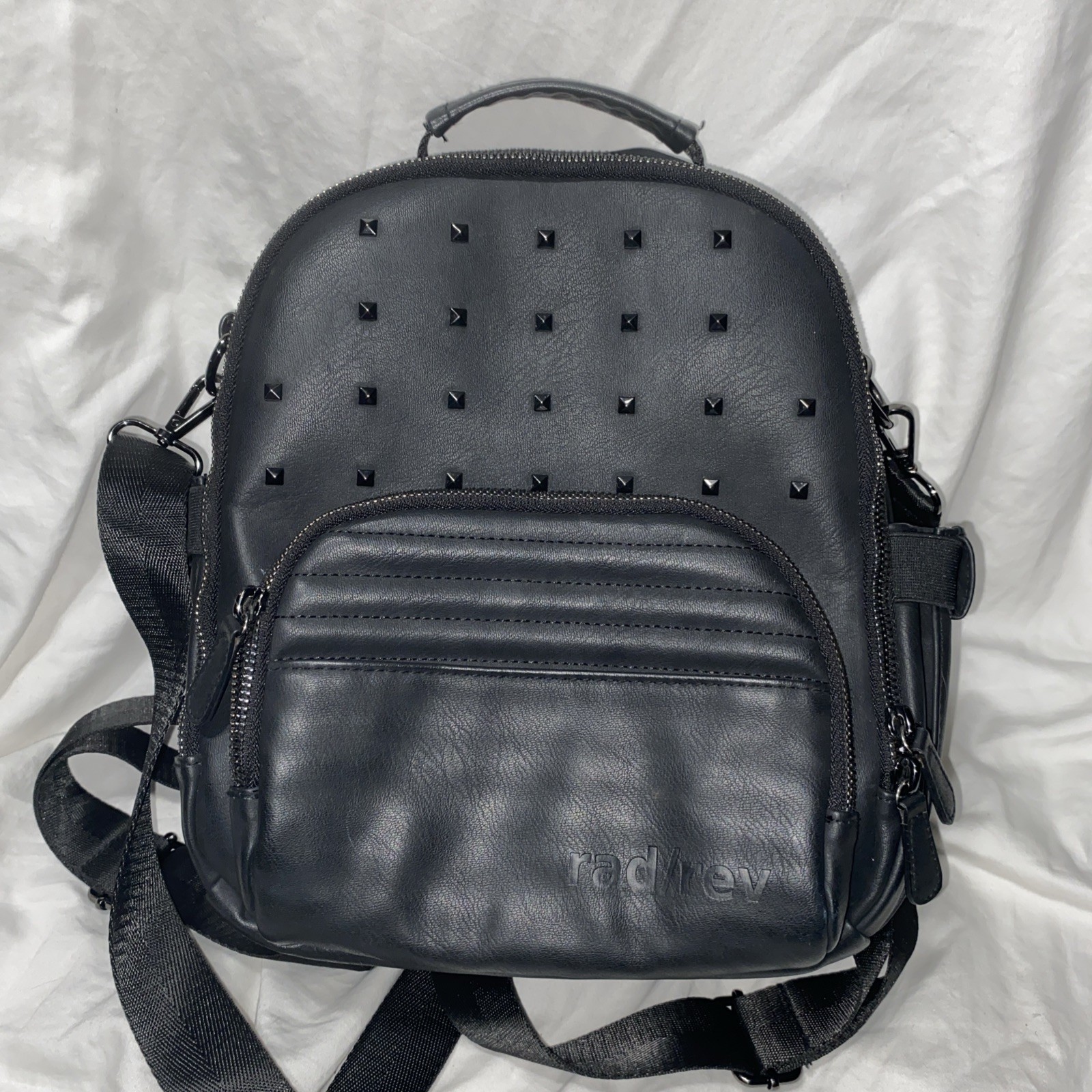 Rad Rev The 1 mini backpack in a matte black finish with gunmetal studs.