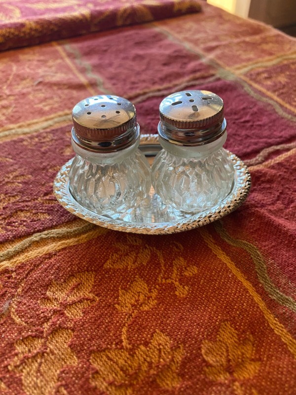 Vintage miniature salt & pepper shakers on silver platter