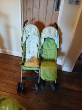 childs double buggy with rain cover