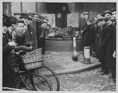 Crowd stand around the scene of a road accident at the corner of C- Old Photo