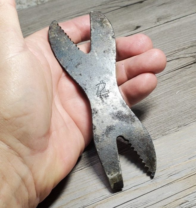 An antique alligator wrench pocket tool bearing the logo of the Big 4 Gas Traction Co — a legitimate piece of early American industrial history you can hold in your hand.