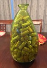 Unique shaped green vase filled with wine corks — photo 4