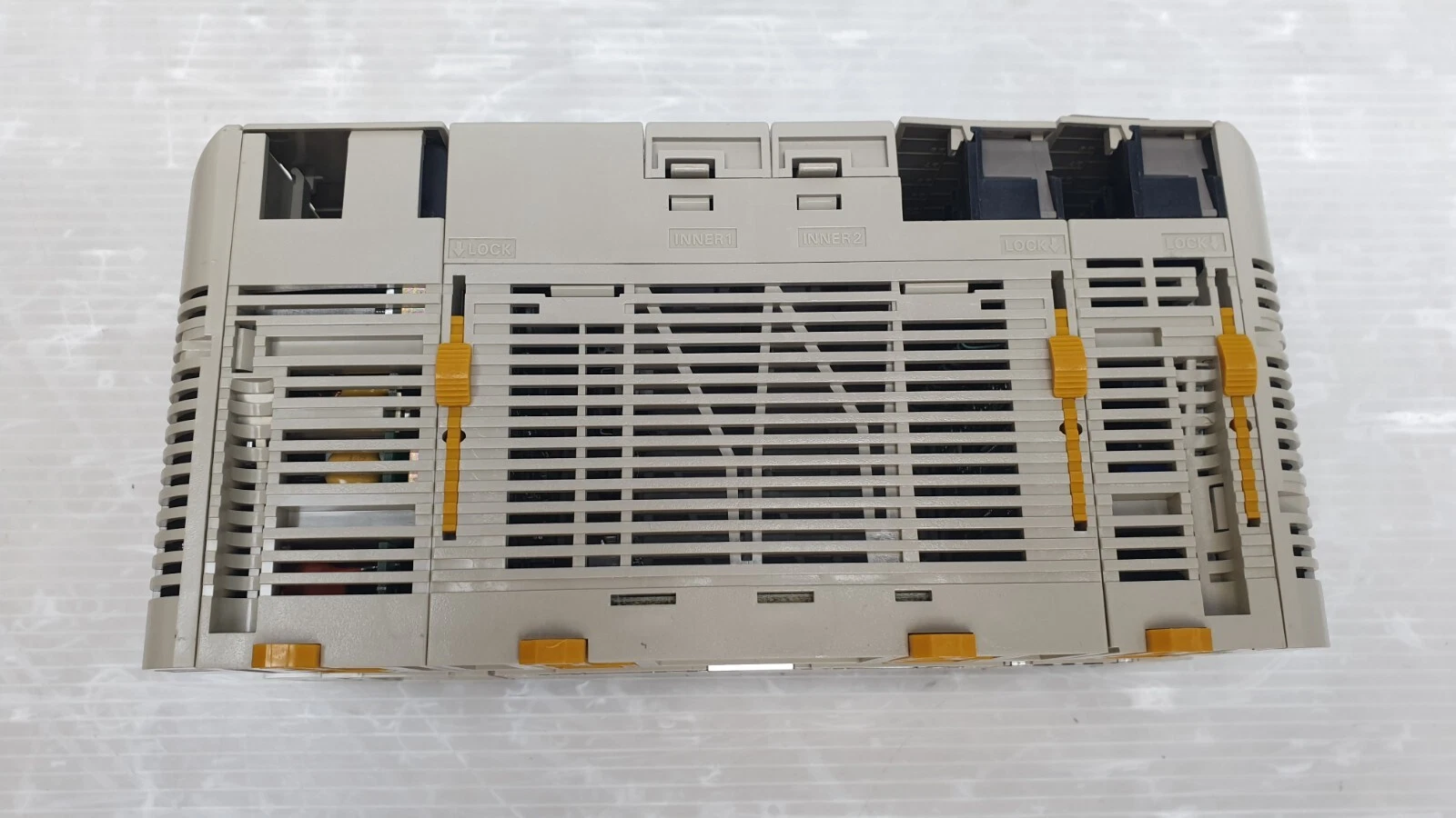Back of the Omron CQM1H PLC modules with vents and DIN-track latches