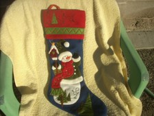 large blue Christmas stocking featuring a snowman