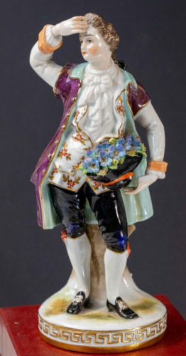 Vintage Hand Painted Porcelain Figurine of a Man Holding a Hat of Flowers. - Photo 1/18