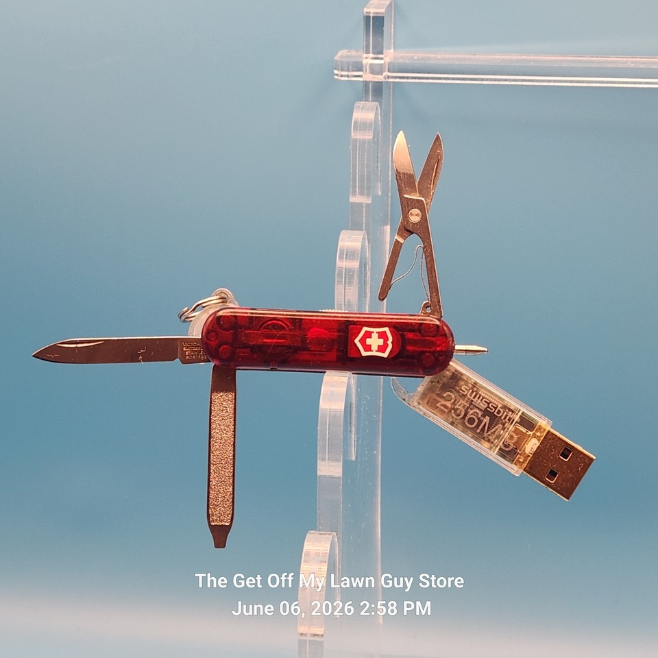A vintage Victorinox Swiss Army Knife with a built-in 256MB USB drive and LED pen — a perfect early-2000s tech time capsule that was ahead of its time.