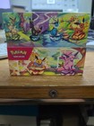 Prismatic Evolutions - Set of 8 Sealed Mini Tins w/ Open Display Box