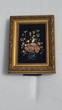 Framed floral arrangement made from vintage jewelry