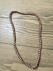 Red, white, and gold beaded necklace with alternating red and white beads #beade — photo 1