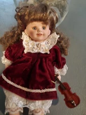 The Axis Corperation Greppeds  Small 12" Sitting Doll Pre Owed Porcelain Dolls