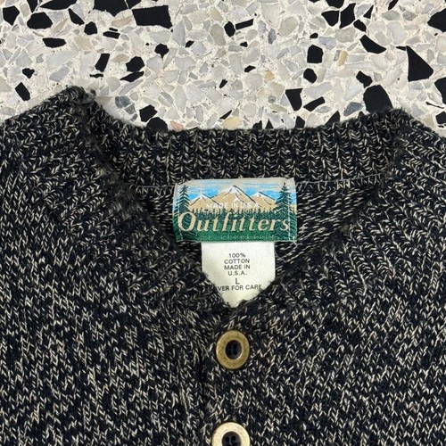 Black and gray vintage 80s 90s Outfitter’s Henley-style sweater with mountain logo and white printed text.
