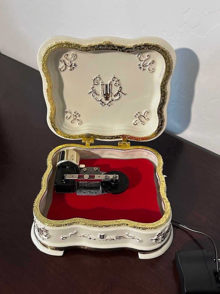 A gold-trimmed all-season porcelain Mr. Christmas Symphonium — this disc-based mechanical music box format is a step above standard wind-ups and looks genuinely opulent on a shelf.