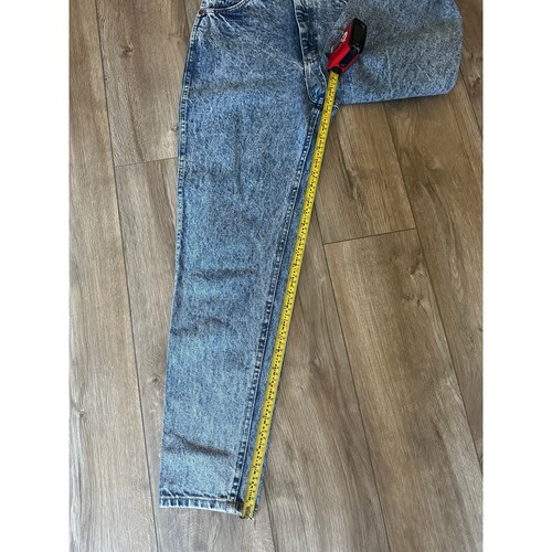 Light blue 90s Lee High Rise Mom Jeans size 8 with yellow measuring tape across the waistband, made in USA.