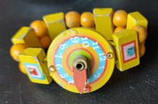 VINTAGE TATIRI LEARNING WATCH. BEAUTIFULLY COLORFUL WOOD, ELASTIC.