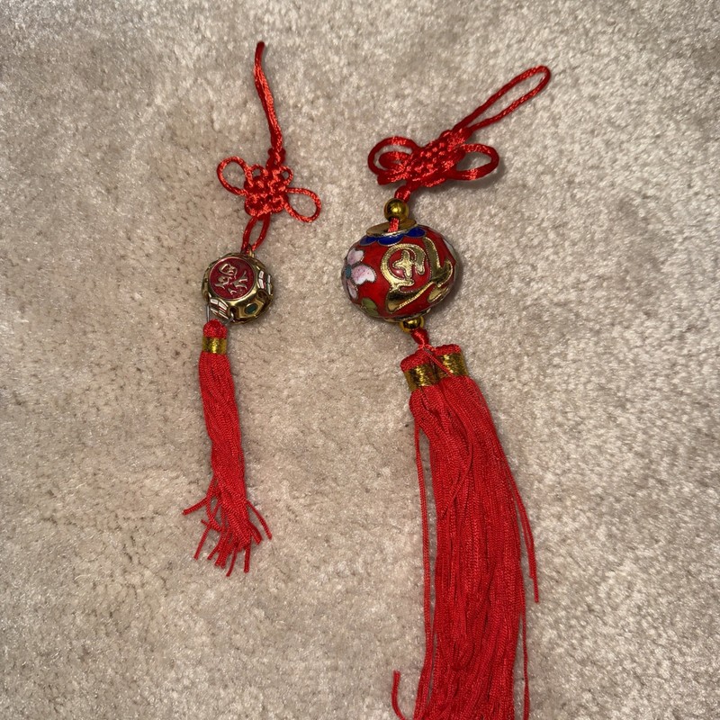 Chinese cloisonné ornament featuring a red floral enamel ball hanging