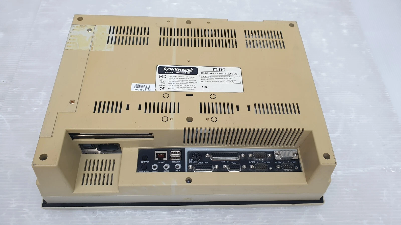 Rear of the STC 12-T panel PC with nameplate, power inlet and I/O panel