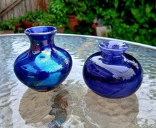 2 x Small Bottles. One Irridescent Blue Ceramic. One Heavy Purple Swirl Glass.