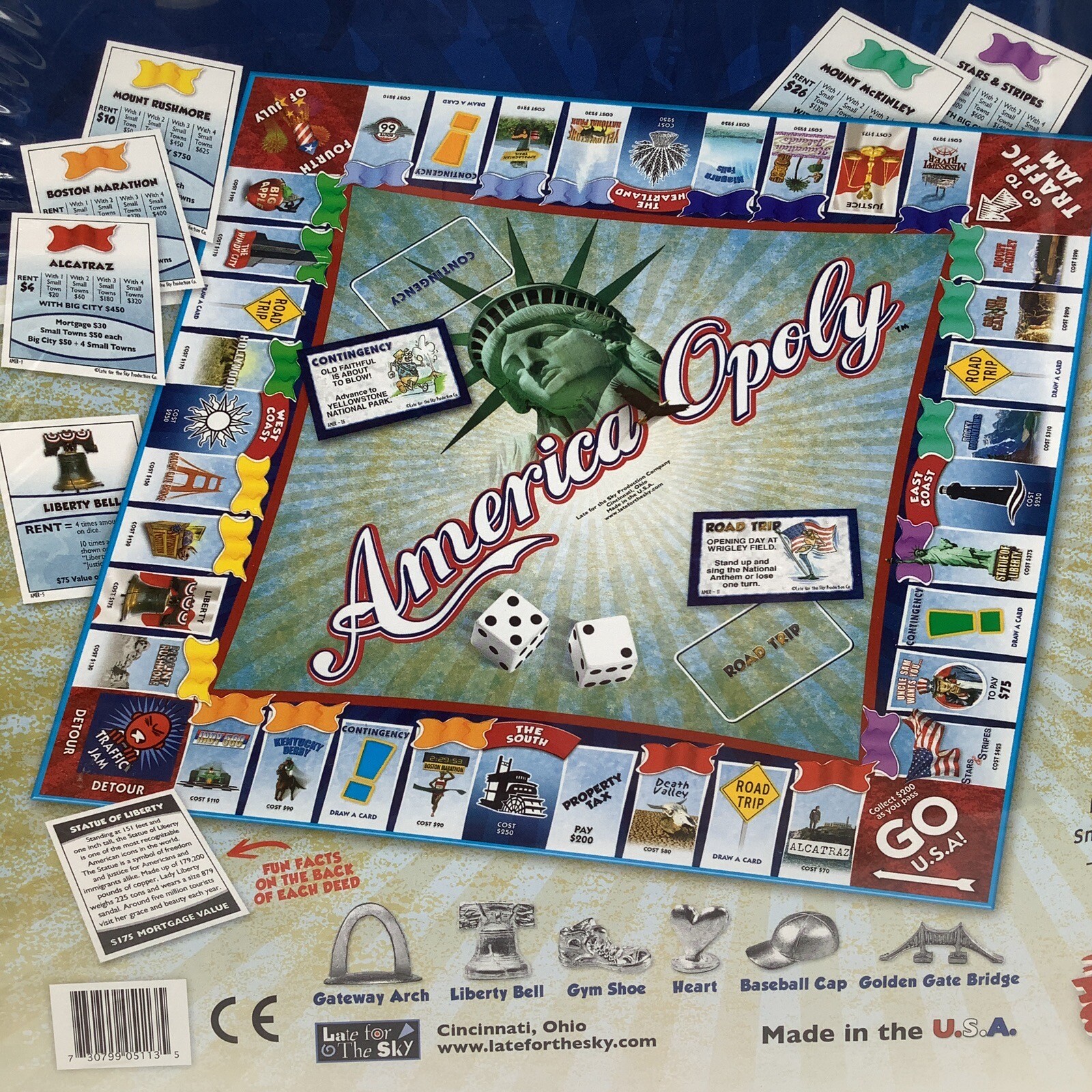 America-Opoly board game box with Statue of Liberty, red map, blue text, and colorful game pieces.