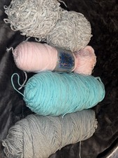 Pink, Gray, and turquoise yarn skeins.