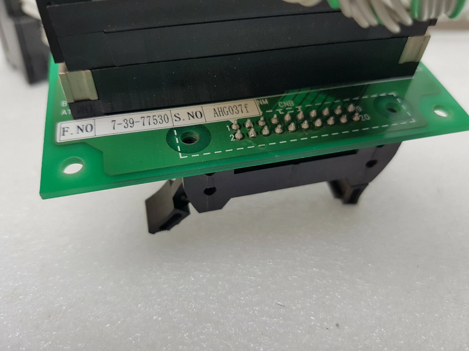 Underside of the I/O divide board with its 7-39-77530 label next to the output unit