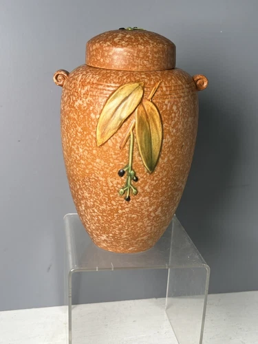 WELLER POTTERY Orange CORNISH JAR WITH LID HAS SOME DAMAGE.