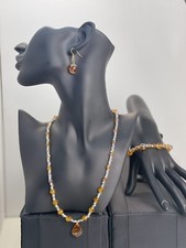 necklace bracelet and earrings set made of brown and transparent beads.Gold Stee
