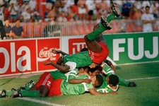 Cameroon players pile on top of each other as they celebrate the w- Old Photo 1