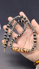 Tibetan Dzi bead necklace, often constructed from agate With Dzi eye bead