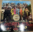 The Beatles - Sgt Peppers - UK 12" Vinyl - 1984 Reissue - Water Damaged Sleeve