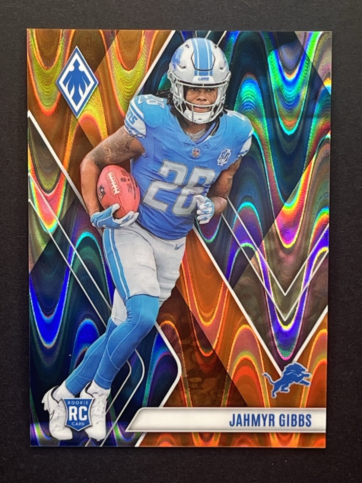 2023 Panini Phoenix Jahmyr Gibbs Orange Wave Prizm /99 Rookie RC #105 Lions NFL