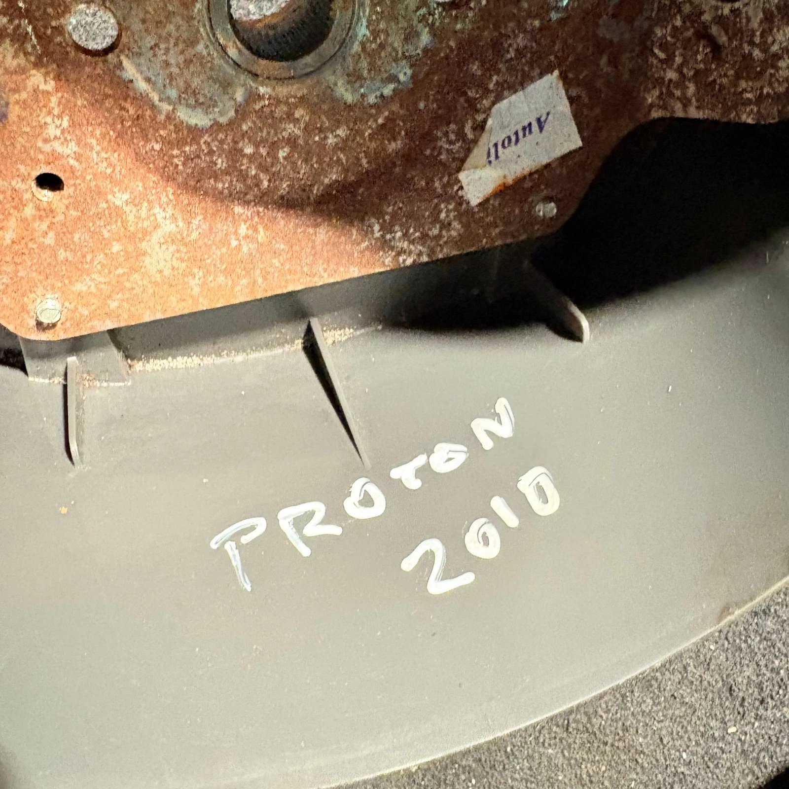 Handwritten Proton 2010 stock marking on steering wheel