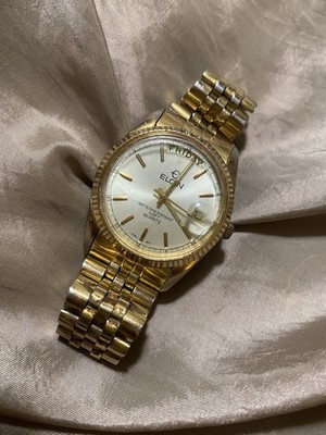 Elgin men's gold & silver quartz wristwatch with analog day/date display