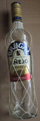 One Brugal Añejo Rum Empty 700 ML Glass Bottle in very good condition.