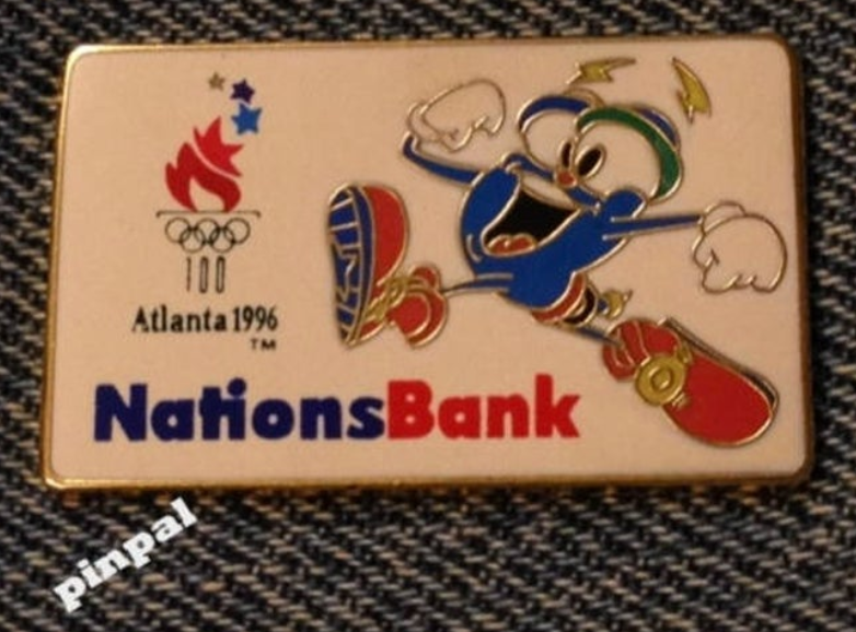 Pin's Jeux Olympiques Atlanta 1996 – Izzy Et Athlètes En Mouvement – Neuf Sous Emballage – Au Choix