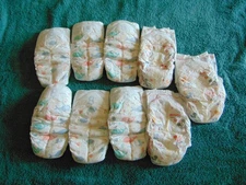 6 Target Up & Up Size 8 Diapers, 3 Huggies Snug & Dry Size 7 Diapers, 9 Total