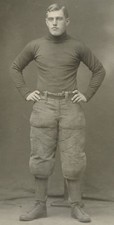 FOOTBALL PLAYER, EARLY 1900s. B AND W PHOTO.