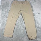 Tan khaki Russell Athletic Champs men’s XL sweatpants with elastic cuffs, laid flat on a textured light gray surface.