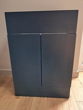 Navy blue combined vanity unit with basin and toilet, brushed brass handles.