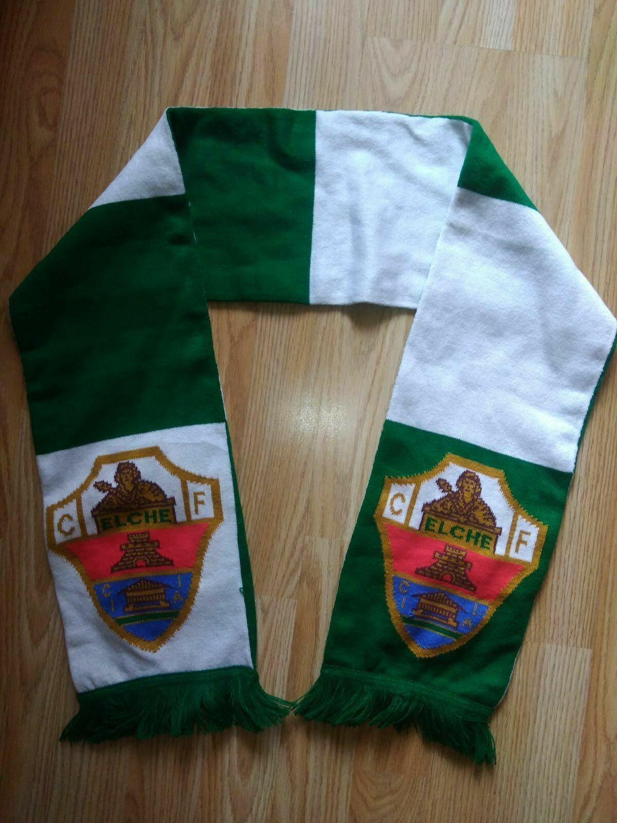 Three bags containing a large collection of football scarves and shirts