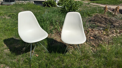 two fair condition used Eames white plastic molded chairs