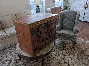 Handmade cabinet with carved teak doors Color range is tan, orange, and brown