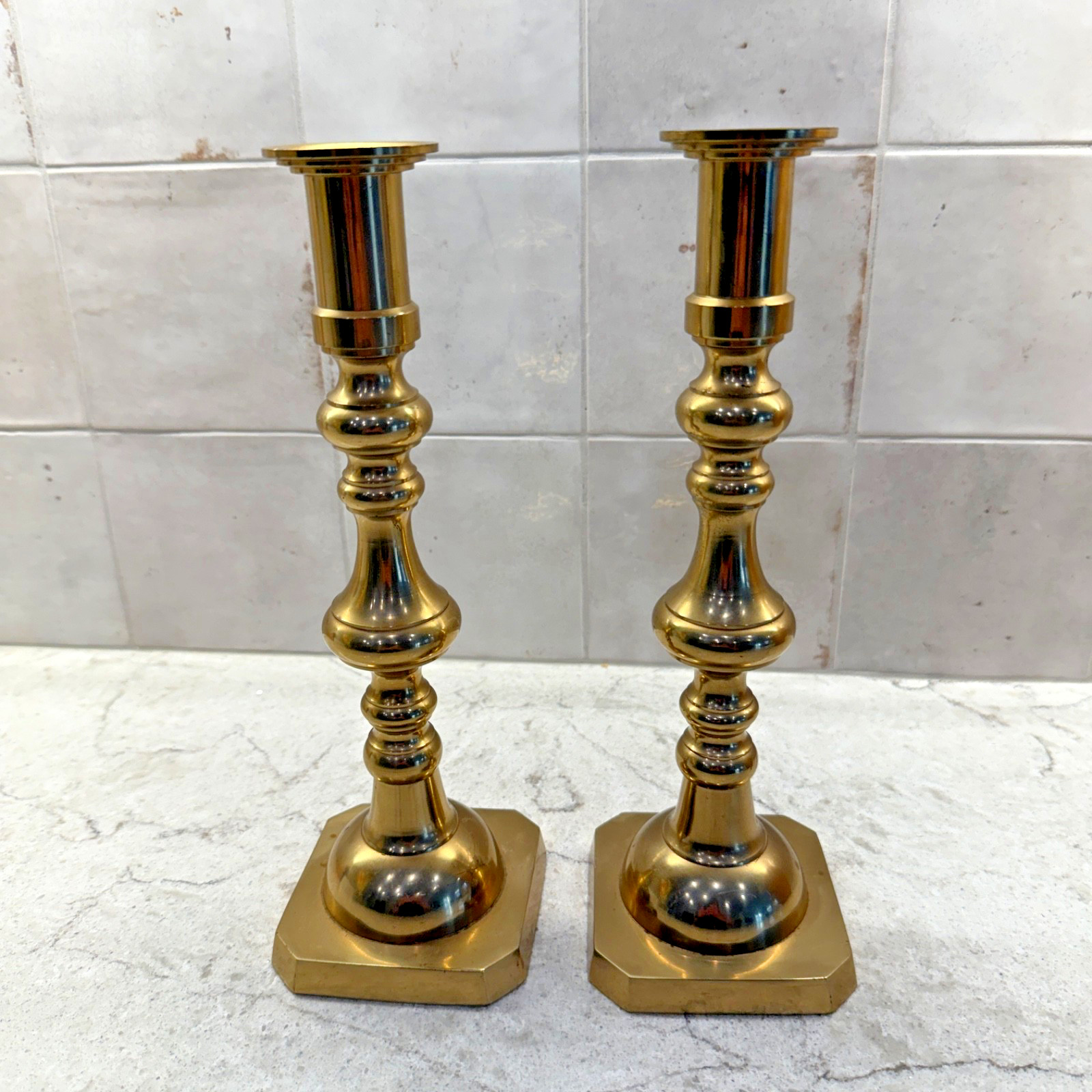Pair of tall solid brass mid-century candlestick holders with a slender tapered stem, made in Japan.