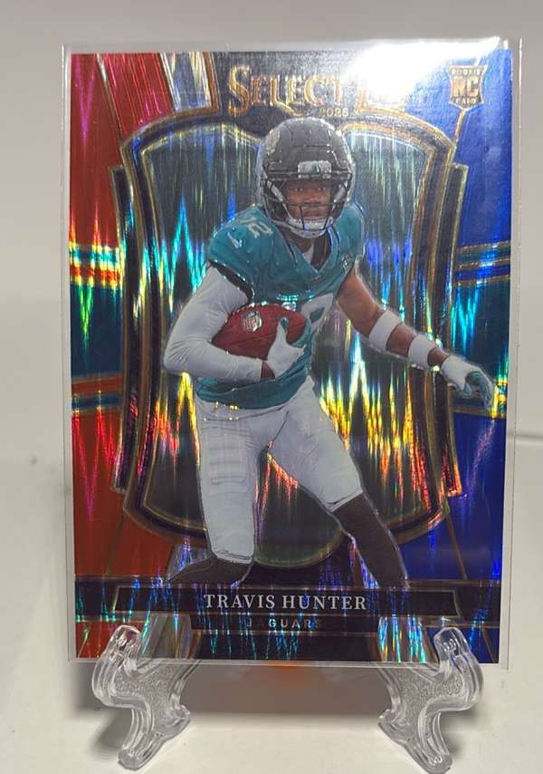 2025 Panini Select - Red and Blue Prizm Shock #128 Travis Hunter Excellent