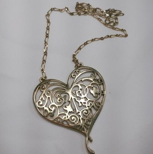 Vintage gold tone rhinestone cupid heart necklace in gold tone metal