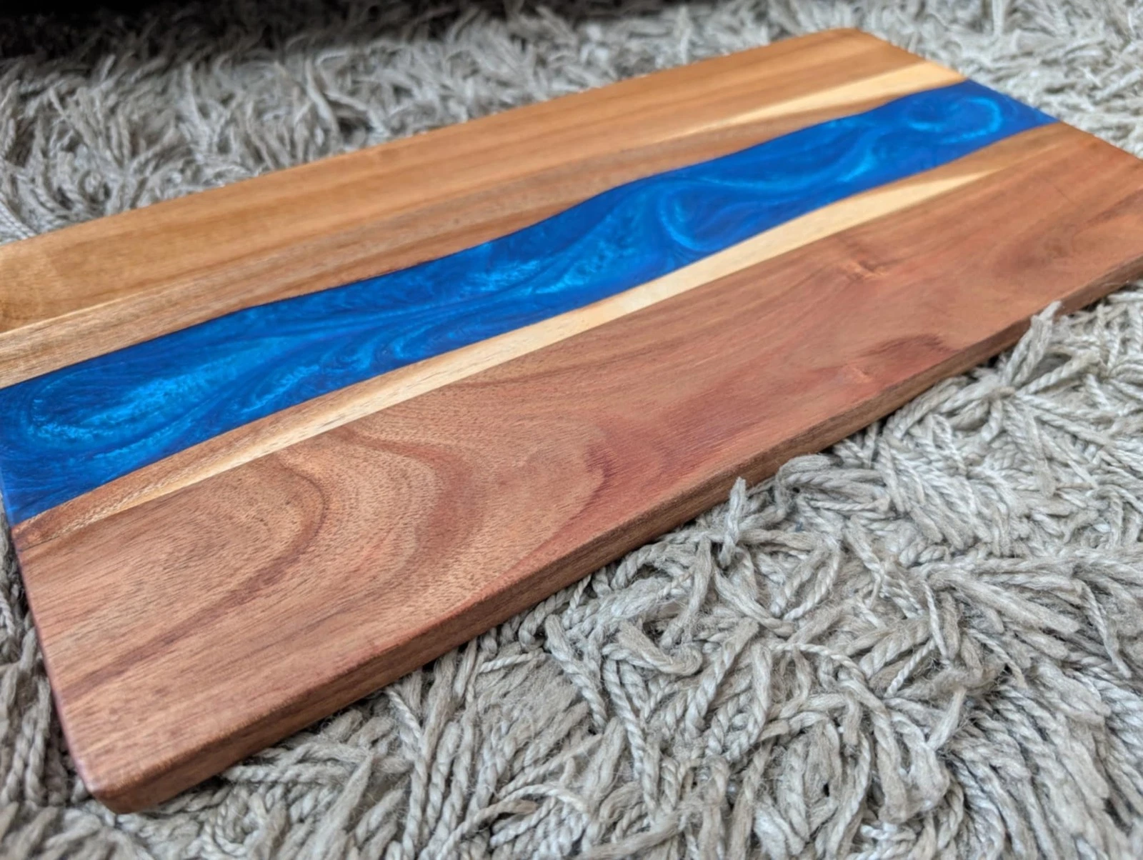 Epoxy resin chopping board sandalwood dark blue river shape resin 45x22cm
Opens in a new window or t