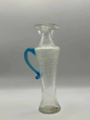 A mid-century Blenko crackle glass mini pitcher with a blue handle.
