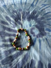 One Phone Charm Made Out Of Plastic With Green A Dark Brown And A Baige